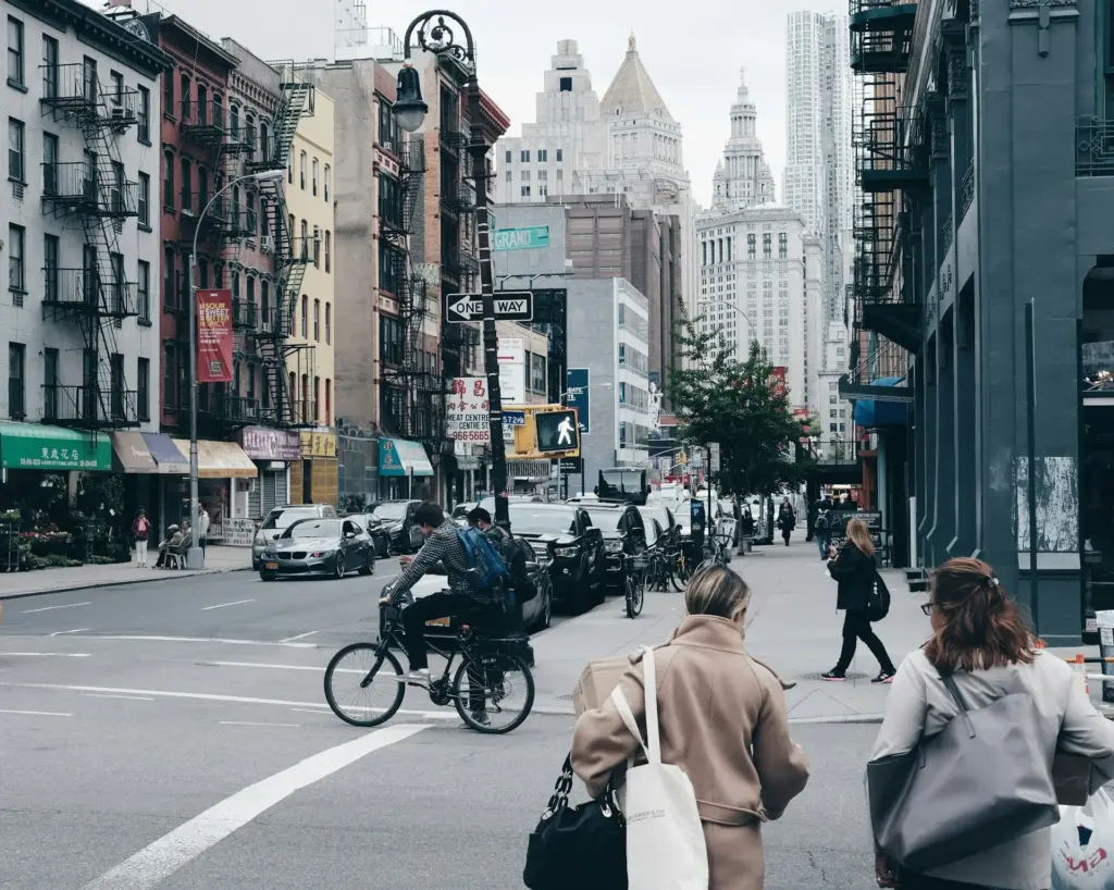 NYC citizens walking along a crosswalk.