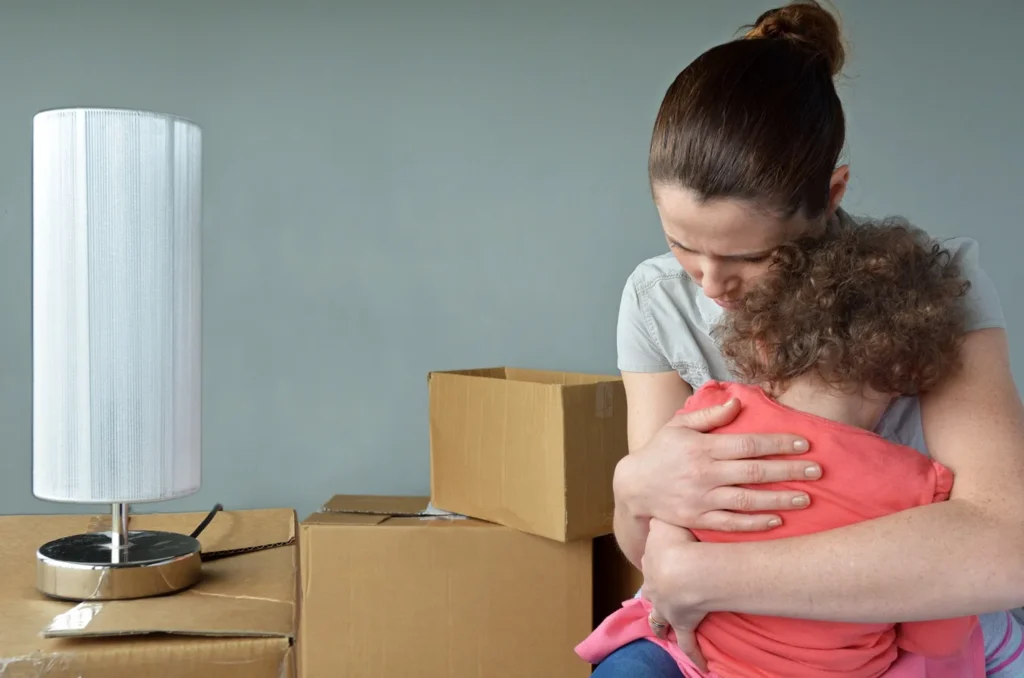 A mom hugging her child after being evicted.