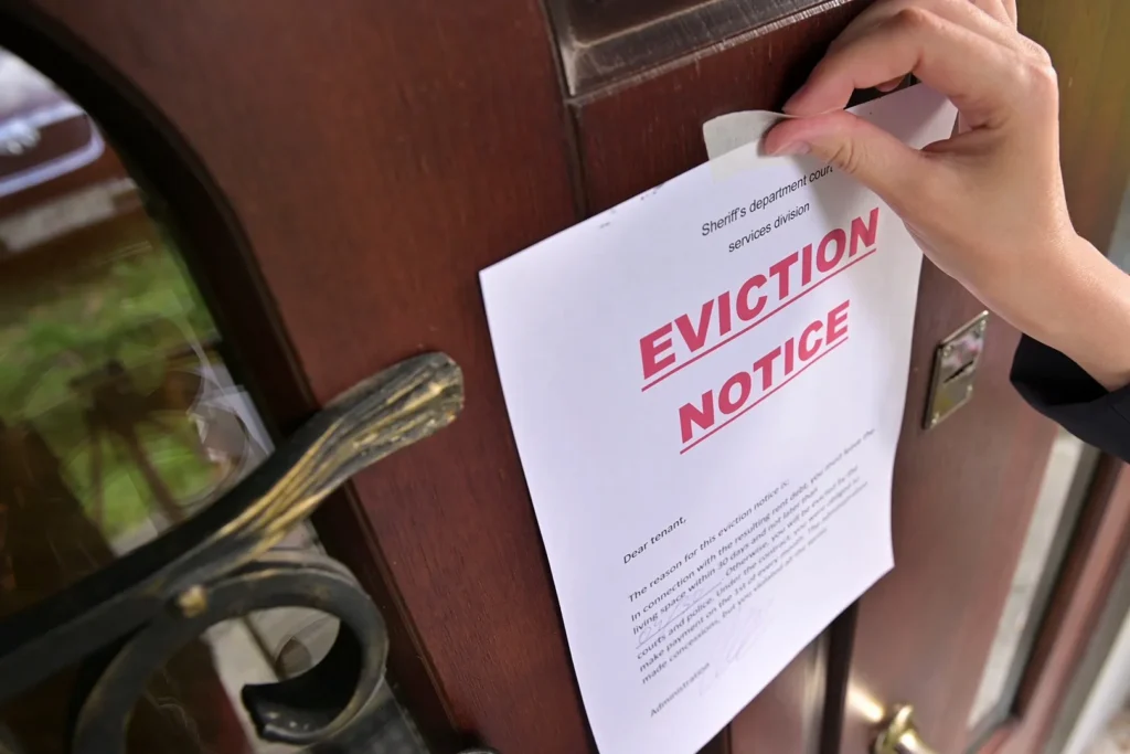 Taping an eviction notice to a New York tenant's front door.